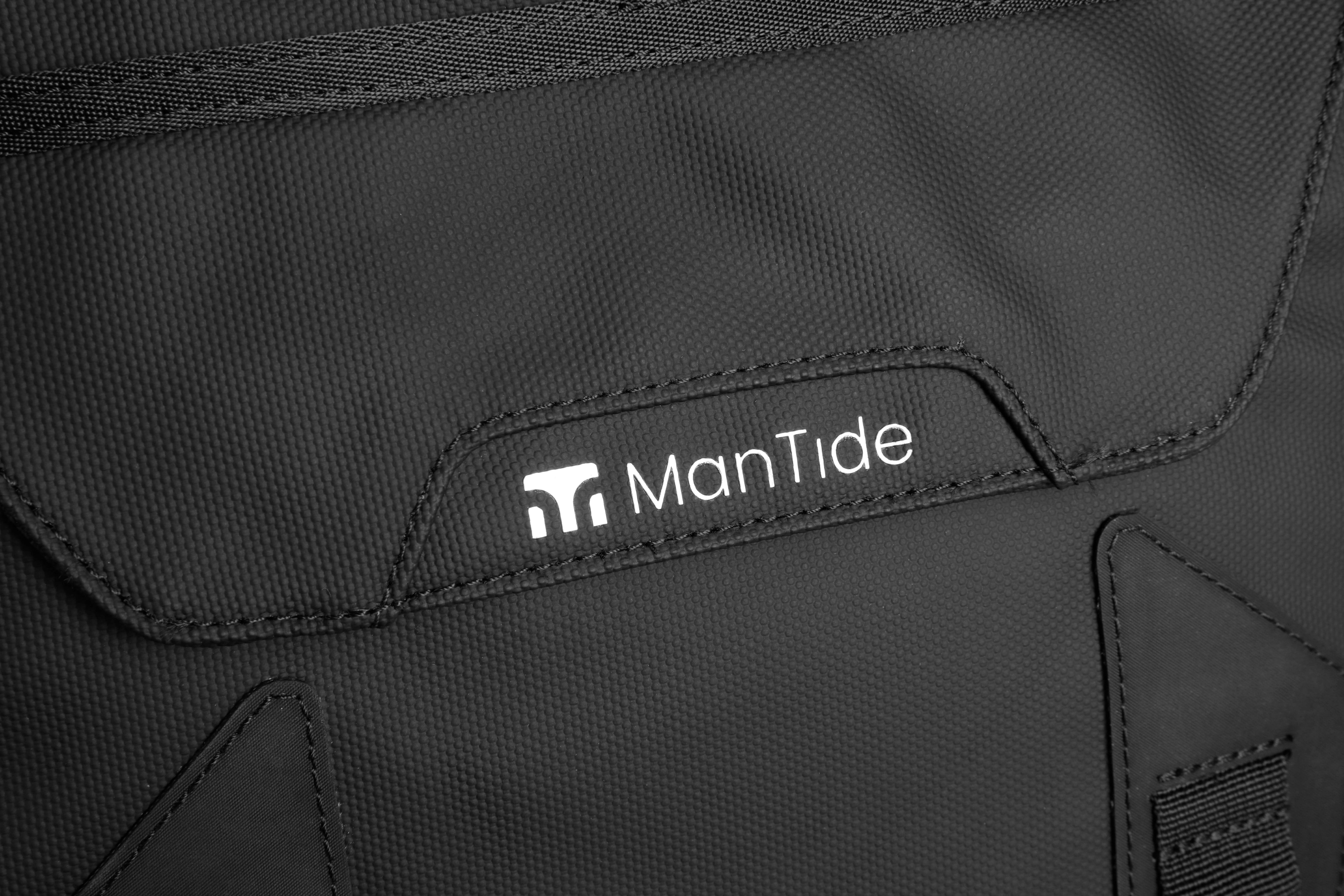 Matte Black TideTrail backpack stylish ManTide logo on large front pocket